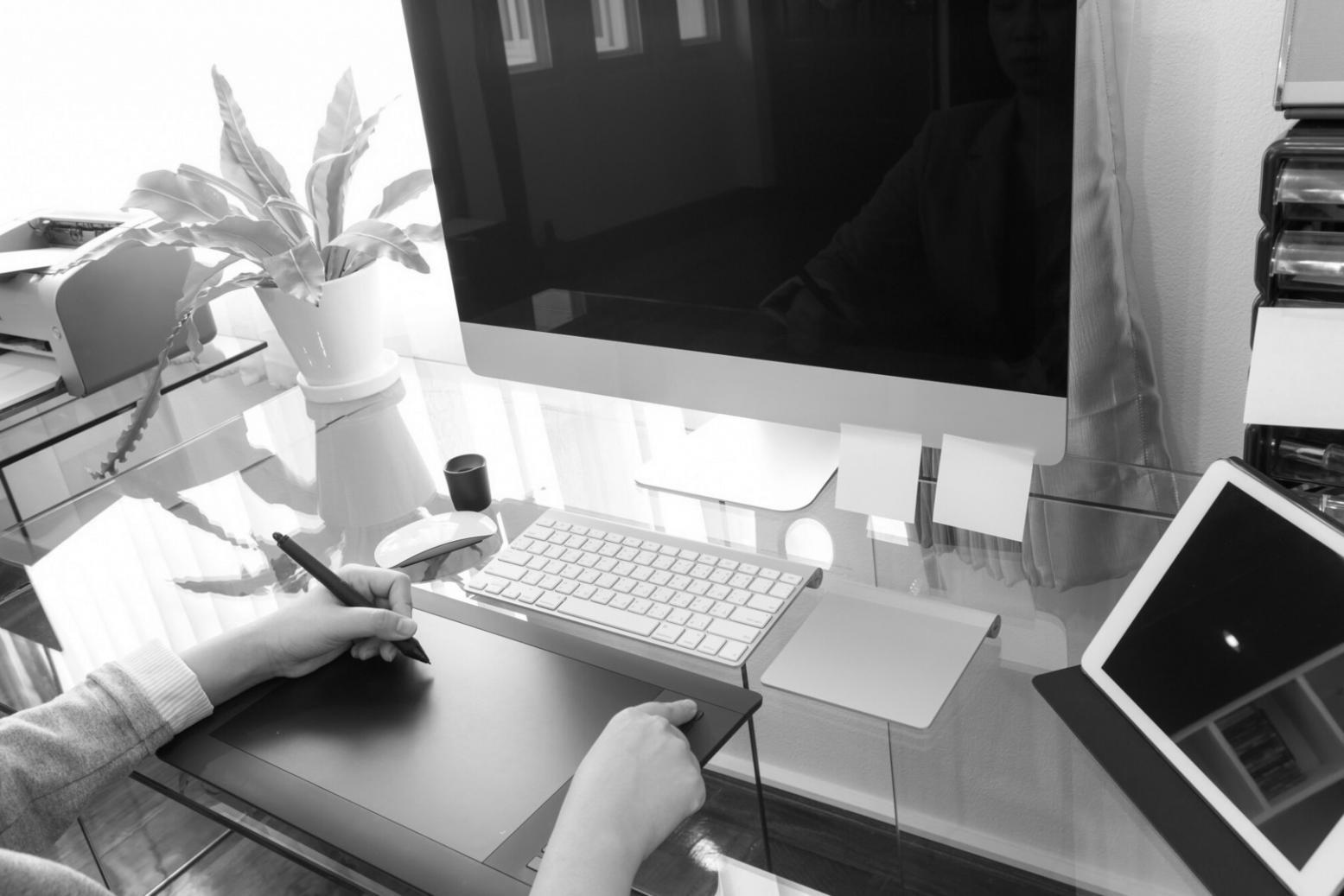 3D environment workspace showing detailed game level design with multiple monitors and professional setup